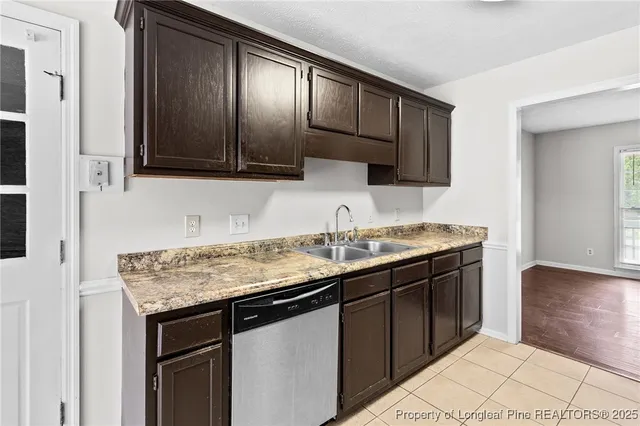 a kitchen with a sink and a wooden cabinets