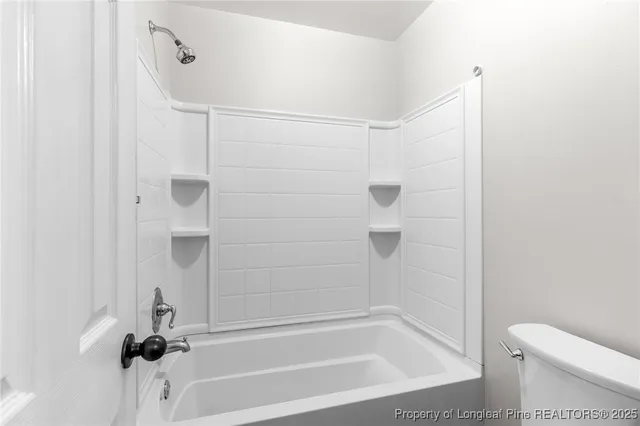 a bathroom with a shower and a toilet