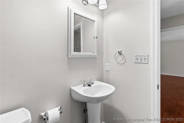 a bathroom with a sink a toilet and mirror