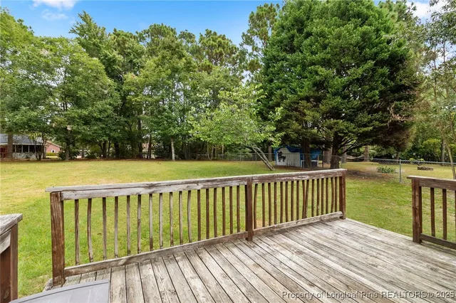 a view of balcony with wooden floor and fence