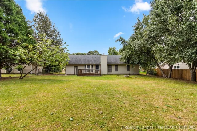 a swimming pool with trees in the background