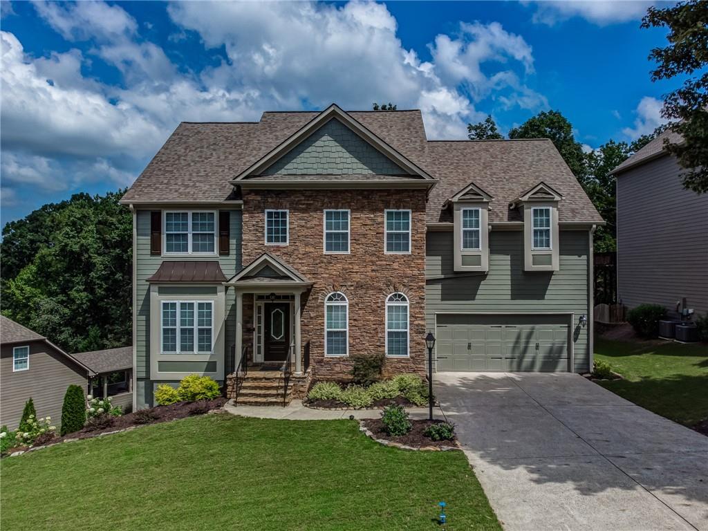 1045 Boxwood Lane Canton, GA 30114 - Photo 1 of 1 a front view of a house with a yard
