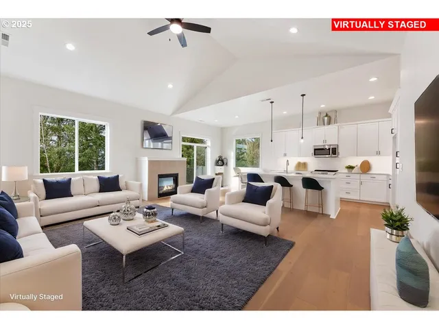 a view of an empty room with a window and kitchen view