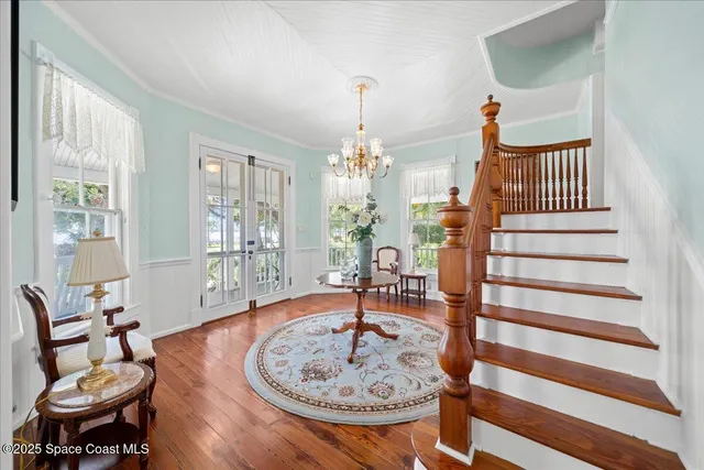 a view of a dining room with furniture and chandelier