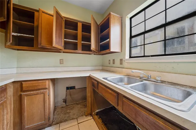a kitchen with stainless steel appliances a sink and a cabinets