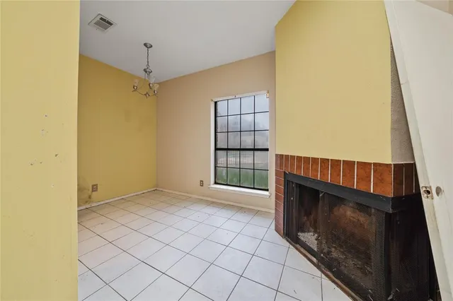 a view of an empty room with a fireplace