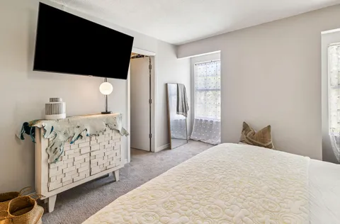 a bedroom with a bed and a painting on the wall