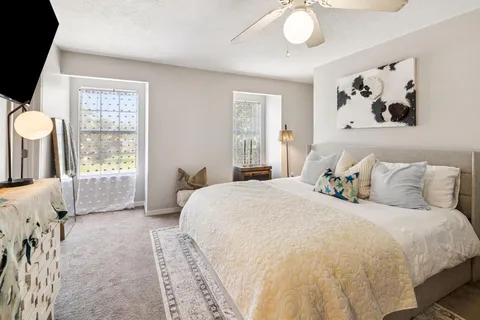 a bedroom with a bed and a chandelier