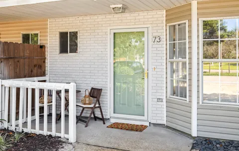 a view of a porch with a table and chairs