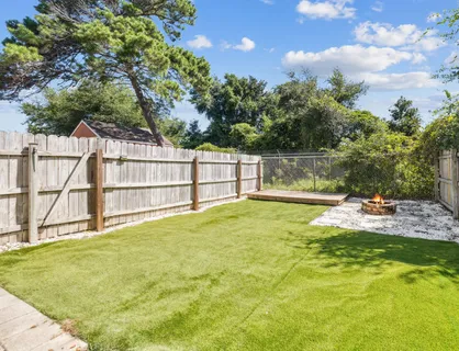 a view of a backyard with a tub and chair