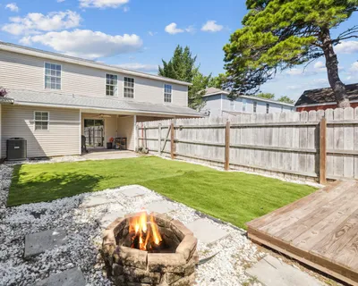 an aerial view of a house with yard and outdoor seating
