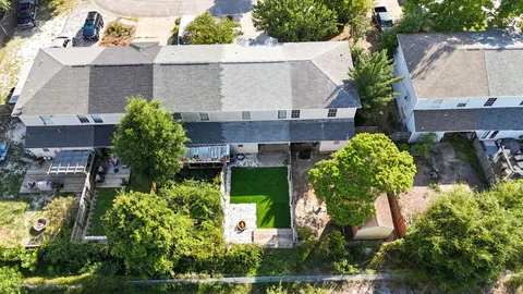 an aerial view of a house with a yard and potted plants
