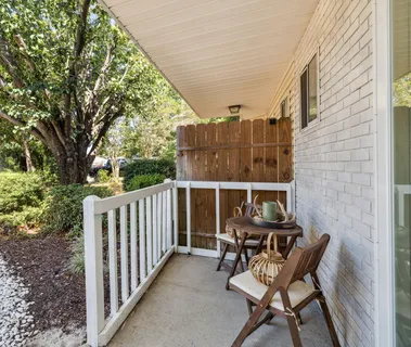 a view of a chair and table in the balcony