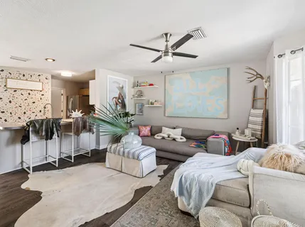 a living room with furniture and a large window