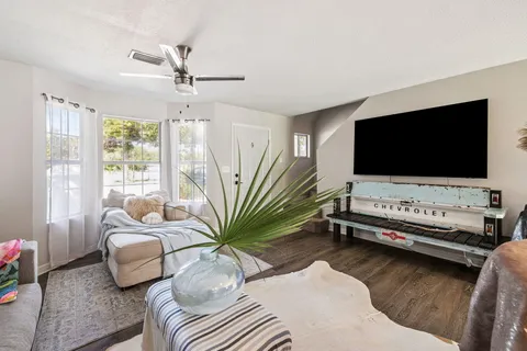a living room with furniture and a flat screen tv