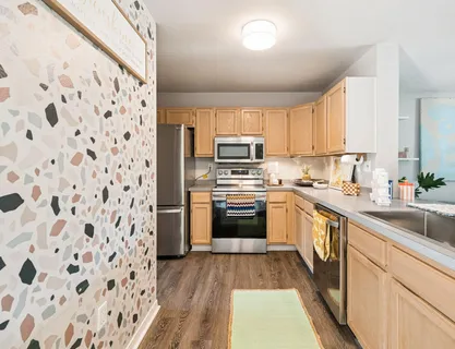 a kitchen with a sink stove and refrigerator