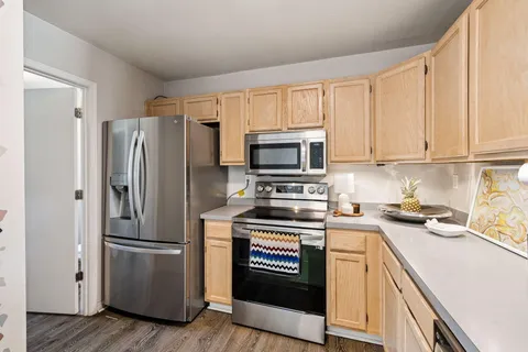 a kitchen with a refrigerator stove and microwave