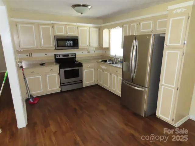 a kitchen with a refrigerator sink and microwave