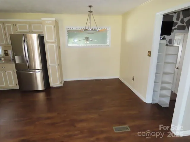 a view of a refrigerator in kitchen and wooden floor