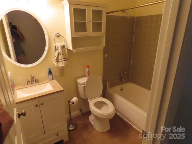 a bathroom with a toilet a sink and bathtub