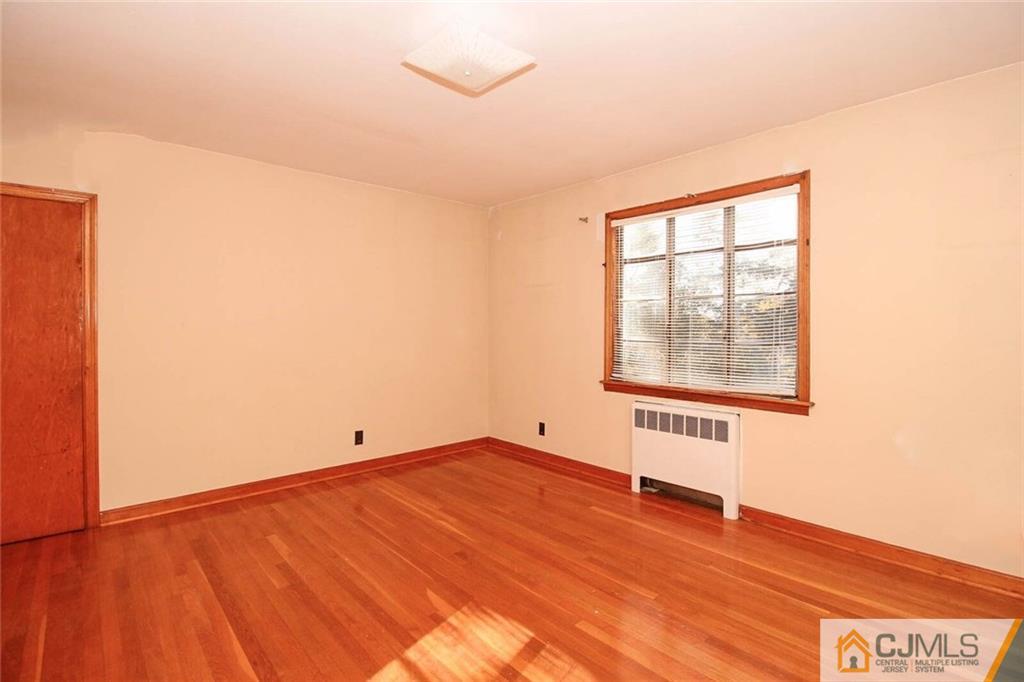 219 Lambertson Road Old Bridge, NJ 07747 - Photo 13 of 21 an empty room with wooden floor and windows