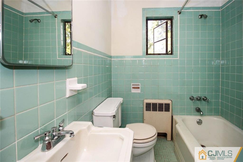 219 Lambertson Road Old Bridge, NJ 07747 - Photo 16 of 21 a bathroom with a sink a toilet and bathtub