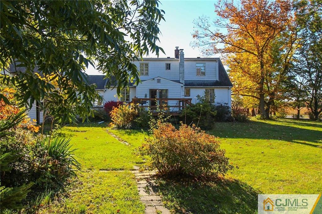 219 Lambertson Road Old Bridge, NJ 07747 - Photo 20 of 21 a view of a house with a big yard and large trees