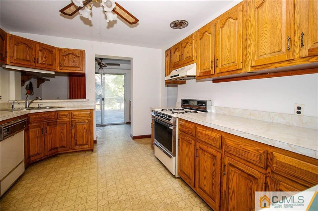 219 Lambertson Road Old Bridge, NJ 07747 - Photo 6 of 21 a kitchen with stainless steel appliances granite countertop a sink and cabinets