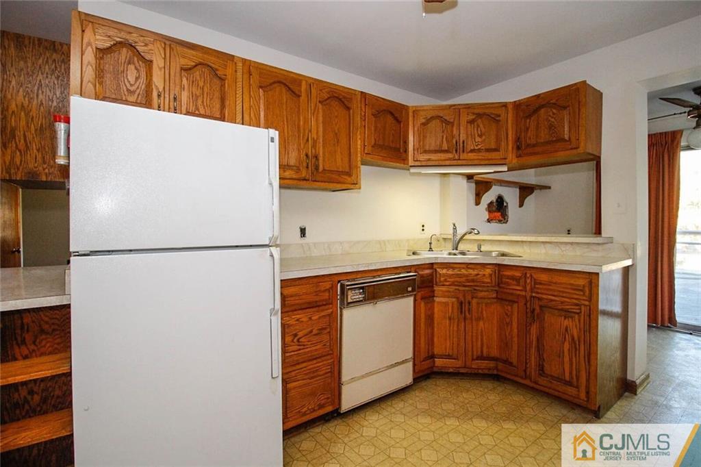 219 Lambertson Road Old Bridge, NJ 07747 - Photo 8 of 21 a kitchen with stainless steel appliances granite countertop a refrigerator a sink and a stove
