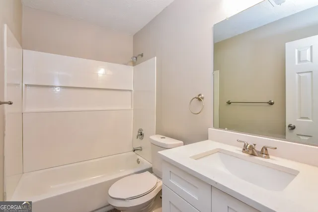 a bathroom with a sink toilet tub and shower