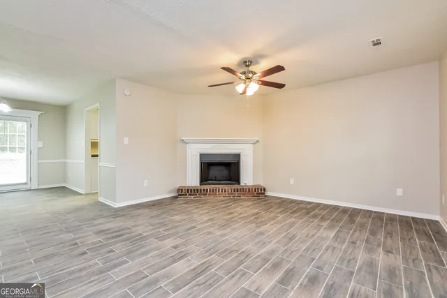 wooden floor in an empty room with a fireplace
