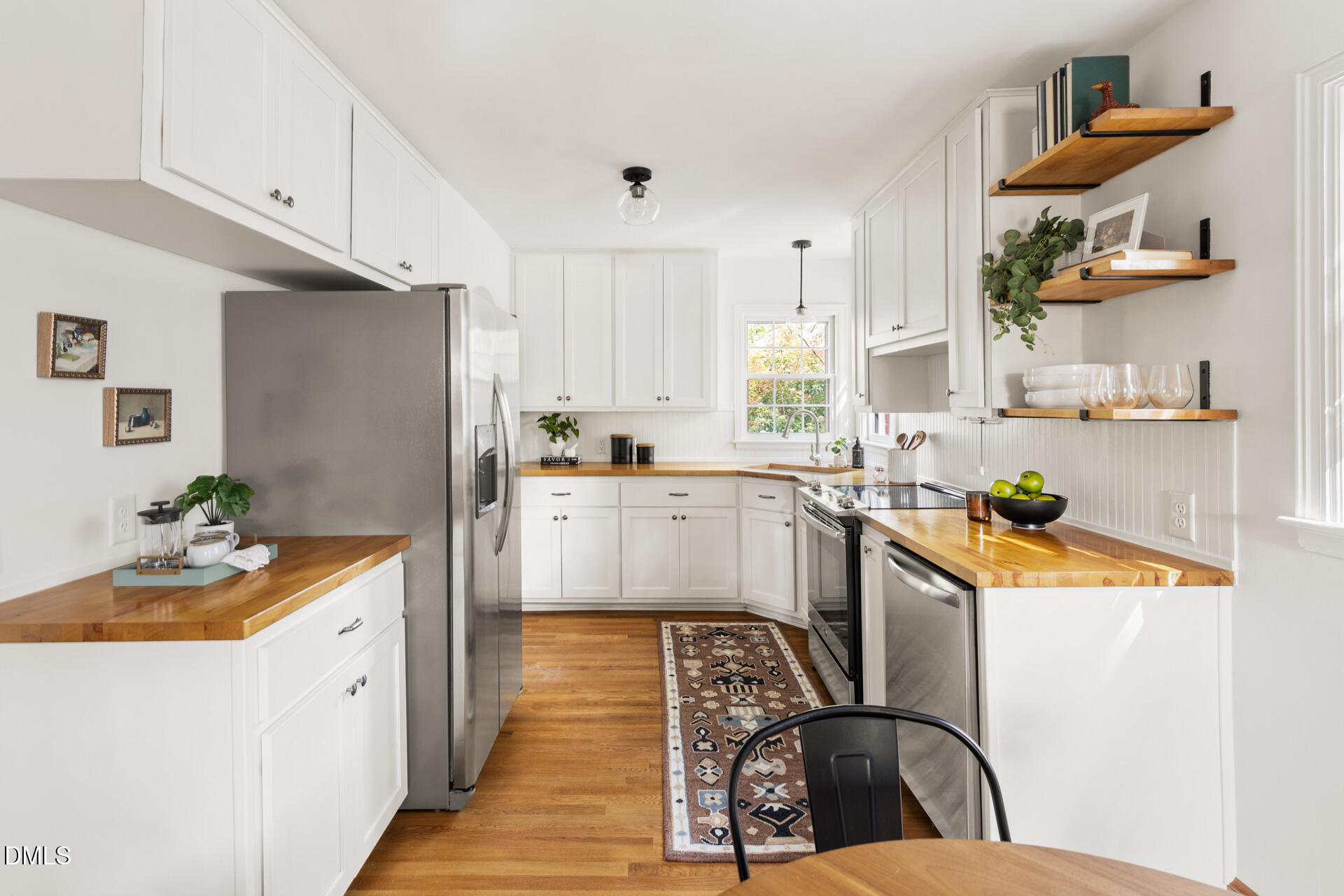 1414 Acadia Street Durham, NC 27701 - Photo 14 of 46 a kitchen with stainless steel appliances granite countertop a sink stove and refrigerator