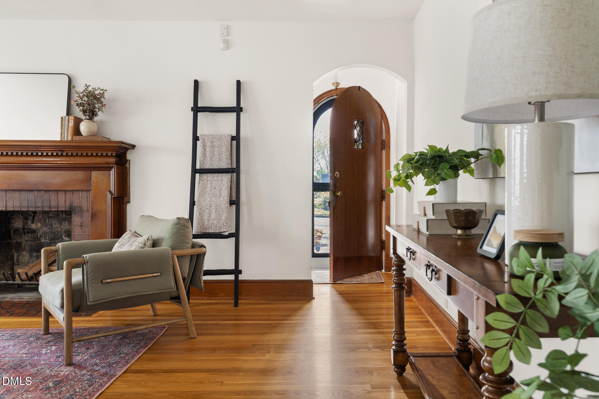 1414 Acadia Street Durham, NC 27701 - Photo 4 of 46 a living room with furniture a table and paintings on the wall