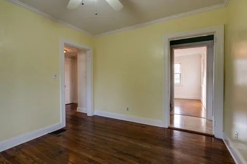 an empty room with wooden floor and closet