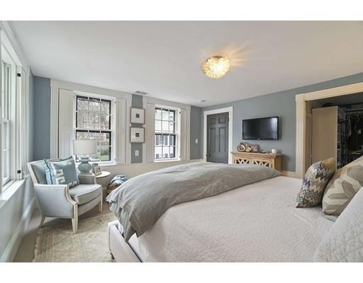 27 Pearl Street Marblehead, MA 01945 - Photo 13 of 25 a spacious bedroom with a bed and a couch