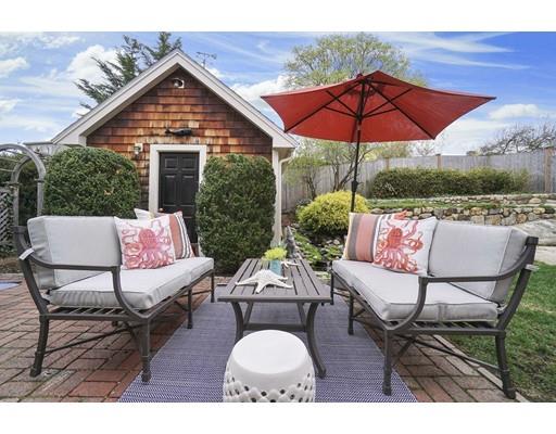 27 Pearl Street Marblehead, MA 01945 - Photo 24 of 25 a patio with a table and chairs under an umbrella