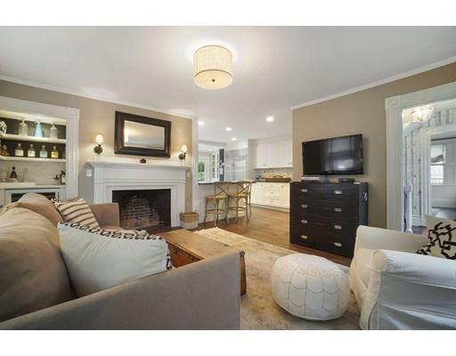27 Pearl Street Marblehead, MA 01945 - Photo 4 of 25 a living room with furniture a flat screen tv and a fireplace