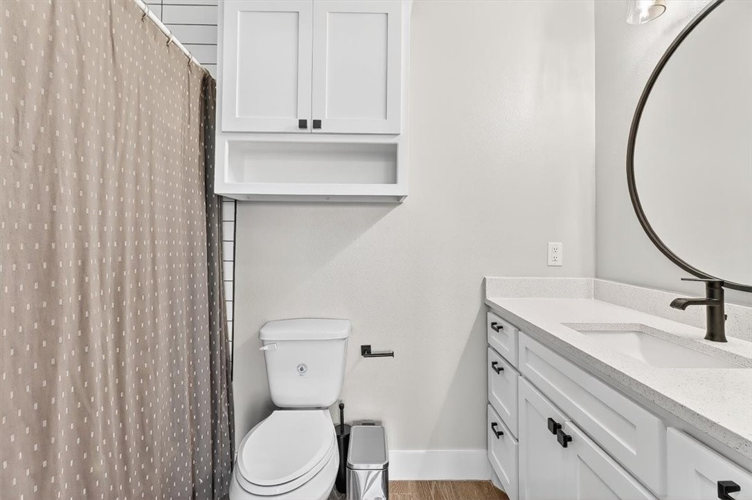 8738 KIng Ranch Drive Corpus Christi, TX 78414 - Photo 25 of 40 a bathroom with a sink a toilet and a mirror