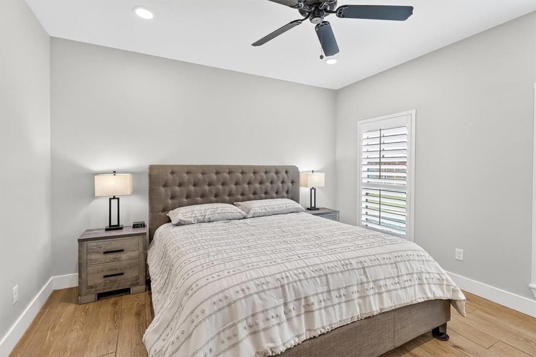 8738 KIng Ranch Drive Corpus Christi, TX 78414 - Photo 26 of 40 a bedroom with a bed and wooden floor