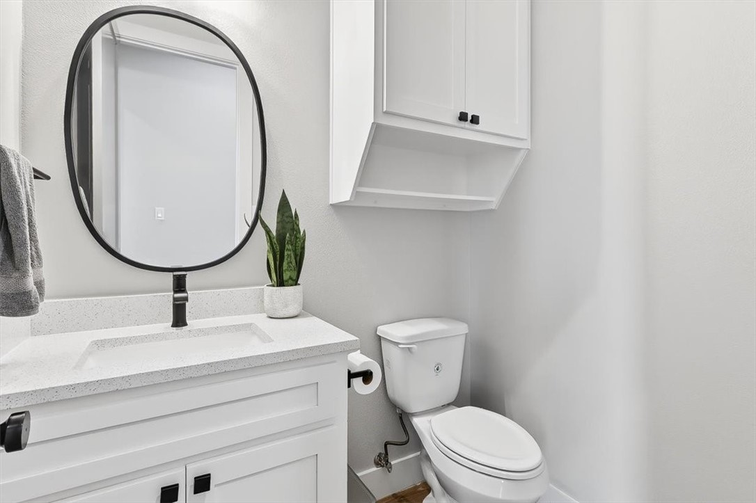 8738 KIng Ranch Drive Corpus Christi, TX 78414 - Photo 32 of 40 a bathroom with a sink mirror and toilet