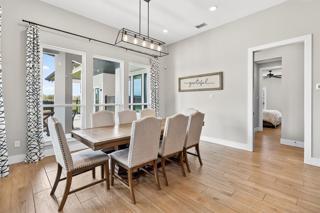 8738 KIng Ranch Drive Corpus Christi, TX 78414 - Photo 5 of 40 a view of a dining room with furniture wooden floor and chandelier
