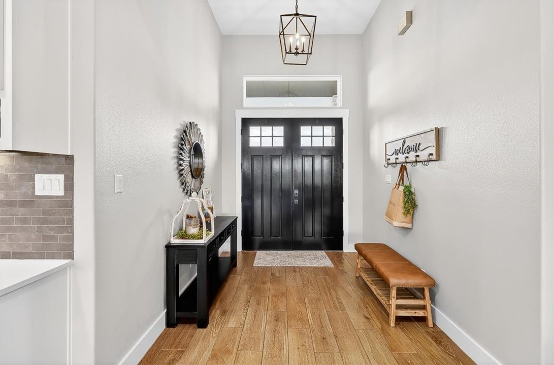 8738 KIng Ranch Drive Corpus Christi, TX 78414 - Photo 10 of 40 a hallway with a wooden floor and entryway