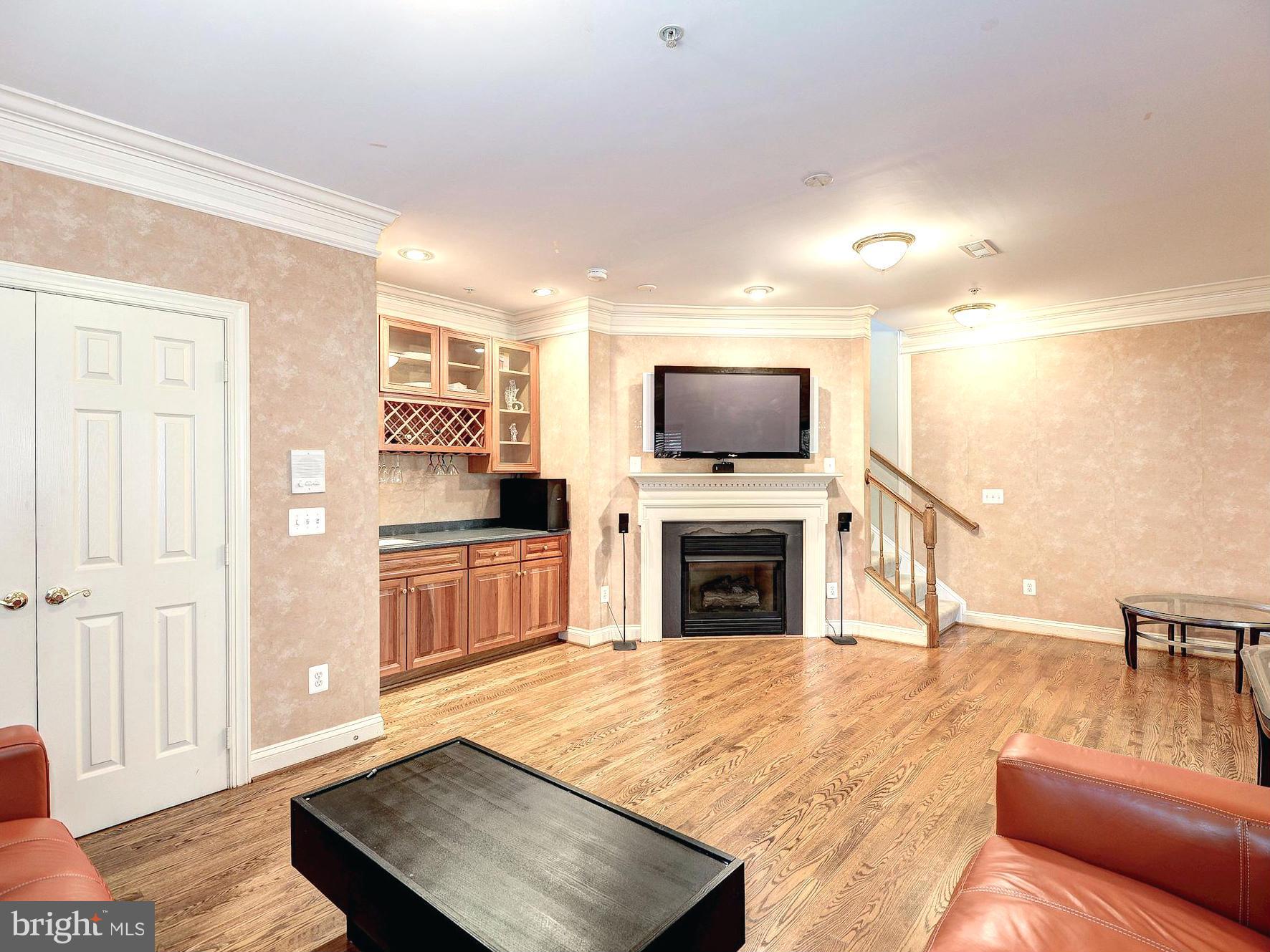 11400 Log Ridge Drive Fairfax, VA 22030 - Photo 9 of 30 a living room with furniture a fireplace and a flat screen tv
