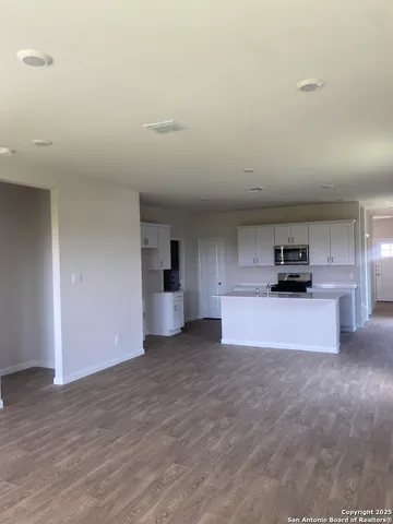 a view of a kitchen with a sink and a stove top oven