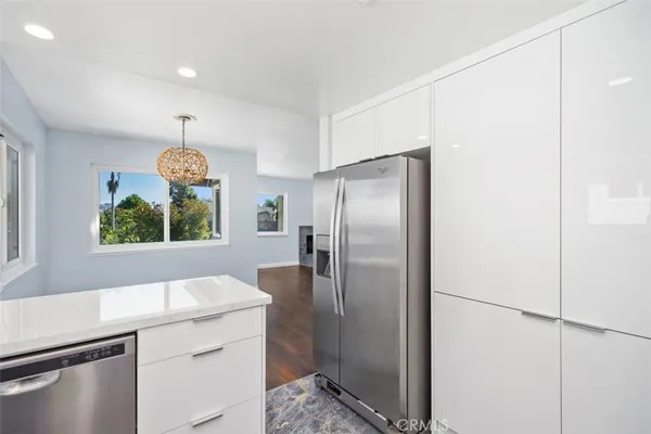 a kitchen with stainless steel appliances granite countertop a refrigerator and a sink