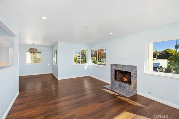 a view of an empty room with a fireplace and a window