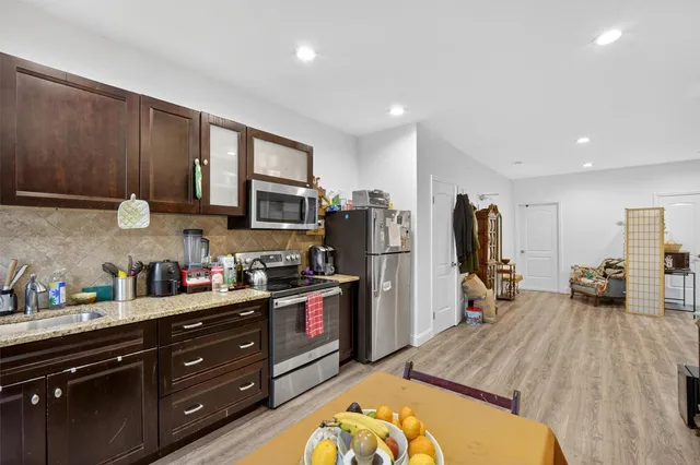 a kitchen that has a lot of cabinets a sink and appliances in it