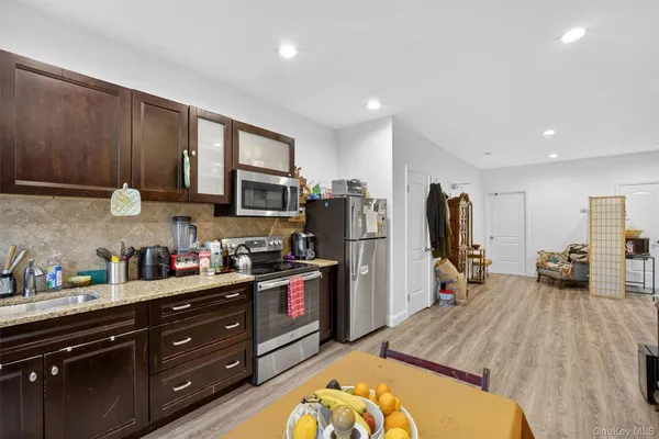 a kitchen that has a lot of cabinets a sink and appliances in it
