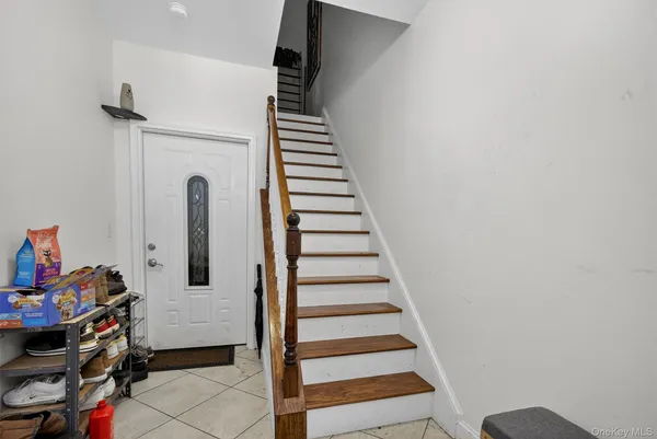 a view of entryway with stairs and front door