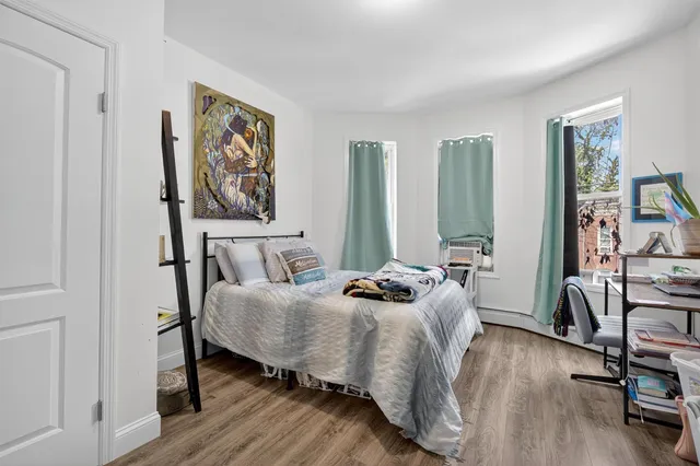 a bedroom with furniture and a wooden floor